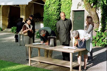 People sign a condolence book dedicated to the memory of Prince Sadruddin Aga Khan, at Aga Khan's residence Chateau de Bellerive above Geneva, Switzerland, Thursday, May 15, 2003. Aga Khan, the former UN High Commissioner for Refugees and uncle of the spiritual leader of the Shiite Muslim Ismaili community, has died at the age of 70 on May 12, 2003, in a hospital in Boston, USA, after a long illness. (AP Photo/Keystone/Gary Ottei)