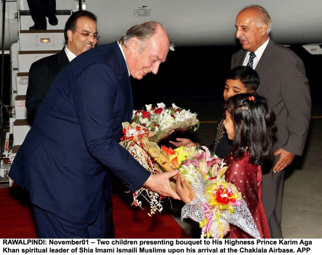 20061101rawalpindi04 RAWALPINDI: November01 – Two children presenting bouquet to His Highness Prince Karim Aga Khan spiritual leader of Shia Imami Ismaili Muslims upon his arrival at the Chaklala Airbase. APP